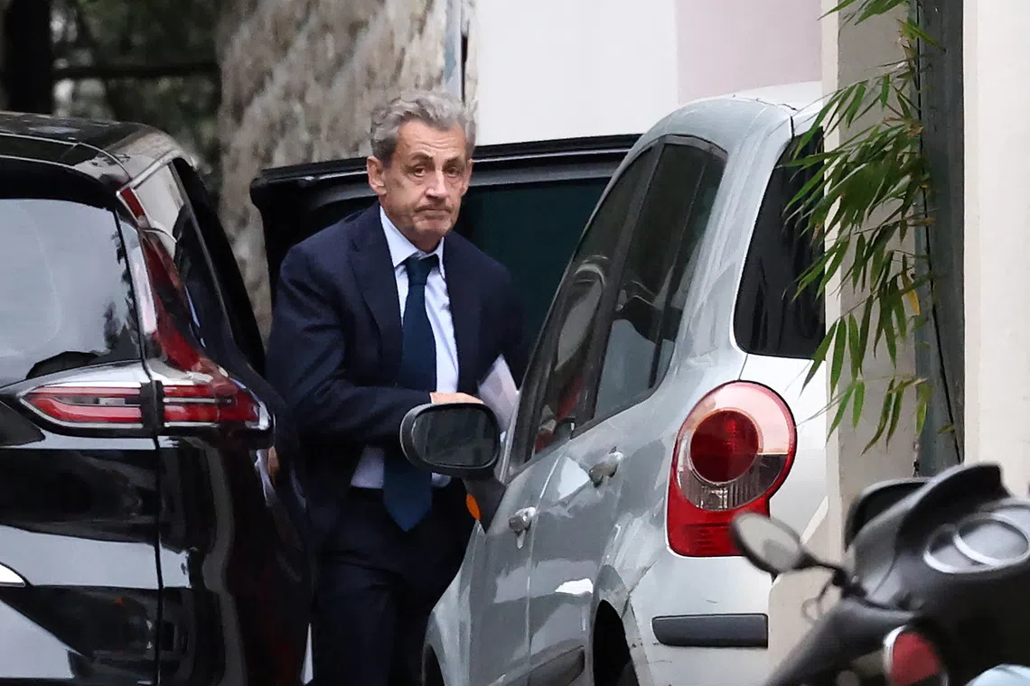 Former French President Nicolas Sarkozy leaves his car as he arrives at his home after being notified of his incarceration date by the National Financial Prosecutor's Office (PNF), following a five-year sentence for criminal conspiracy over attempts to raise campaign funds from Libya, in Paris, France, October 13, 2025. REUTERS/REUTERS/Stephane Mahe