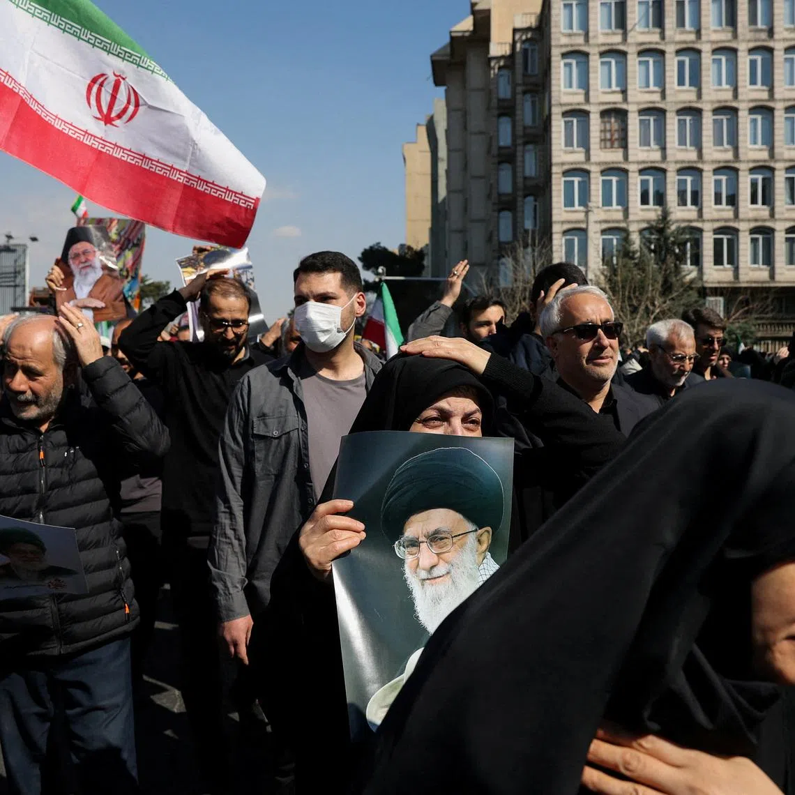 A demonstrator holds an image of Iran's late Supreme Leader Ayatollah Ali Khamenei, after he was killed in Israeli and U.S. strikes on Saturday, during an anti-Israeli and U.S. rally after Friday prayer, amid the U.S.-Israeli conflict with Iran, in Tehran, Iran, March 6, 2026. Majid Asgaripour/WANA (West Asia News Agency) via REUTERS