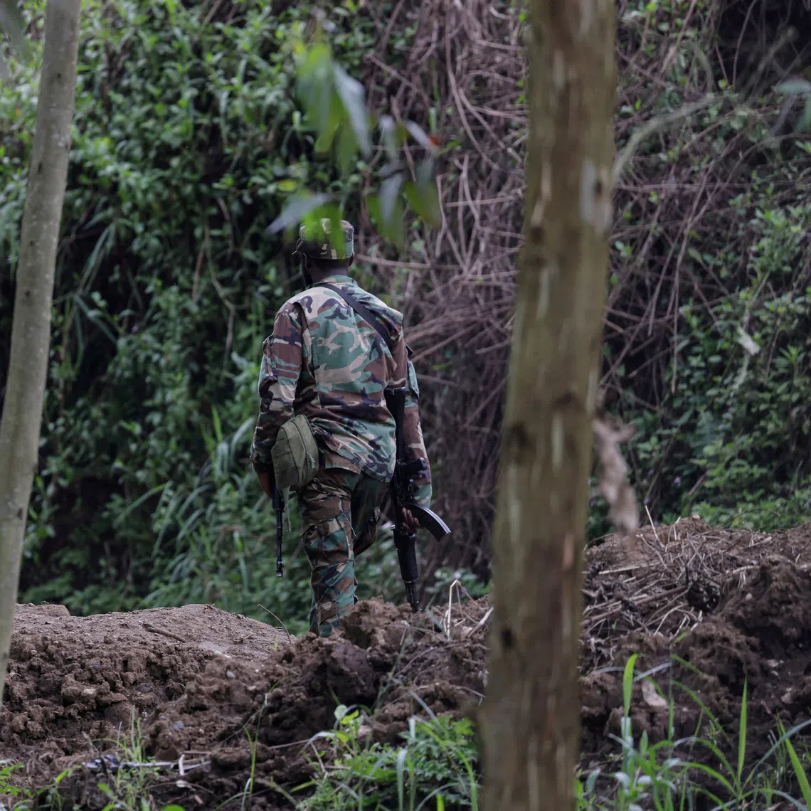 FILE PHOTO: An M23 rebel walks on the outskirts of Matanda which is controlled by M23 rebels, in eastern Democratic Republic of Congo, March 22, 2025. REUTERS/Zohra Bensemra/File Photo