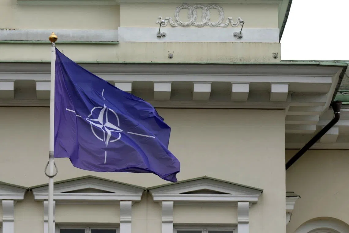 FILE PHOTO: A NATO flag flutters next to the Presidential Palace in Vilnius, Lithuania July 10, 2023. REUTERS/Ints Kalnins/File Photo