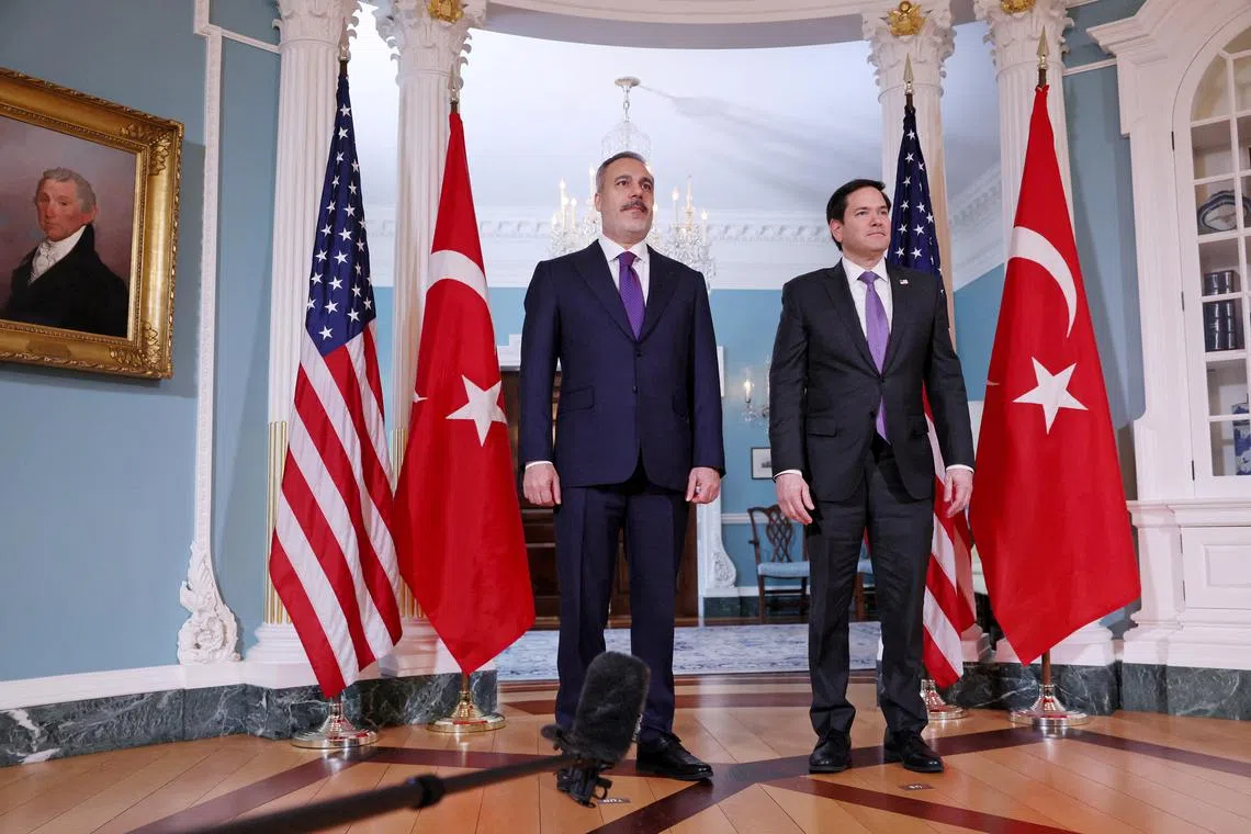FILE PHOTO: U.S. Secretary of State Marco Rubio poses with Turkish Foreign Minister Hakan Fidan for members of the news media at the State Department in Washington, D.C., U.S., March 25, 2025. REUTERS/Leah Millis/File Photo