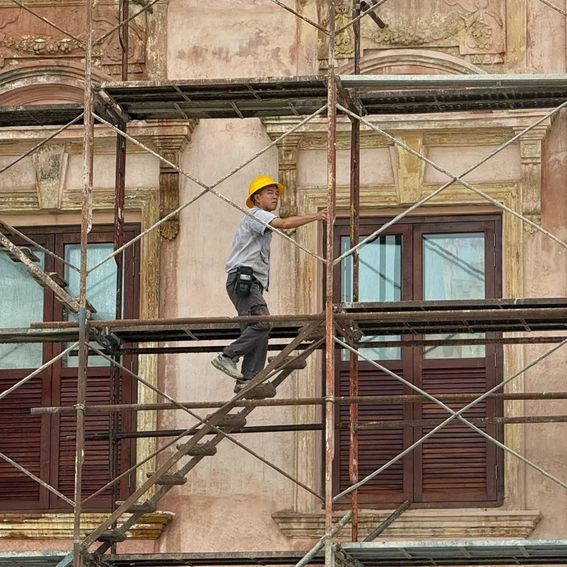 A​ construction worker during restoration work on a heritage building facade at Medan Pasar in Kuala Lumpur on Oct 13.