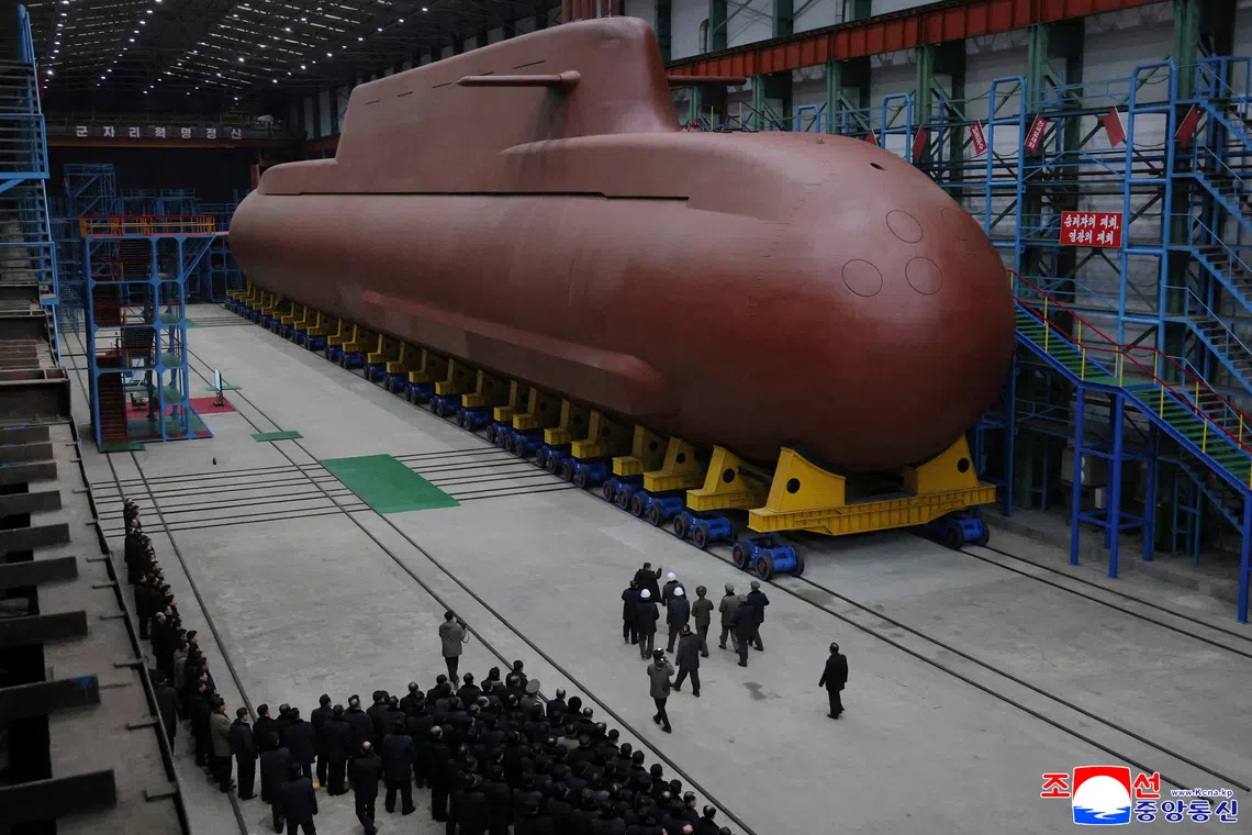 North Korean leader Kim Jong Un visits the construction site of an 8,700-ton nuclear-powered submarine capable of launching surface-to-air missiles.