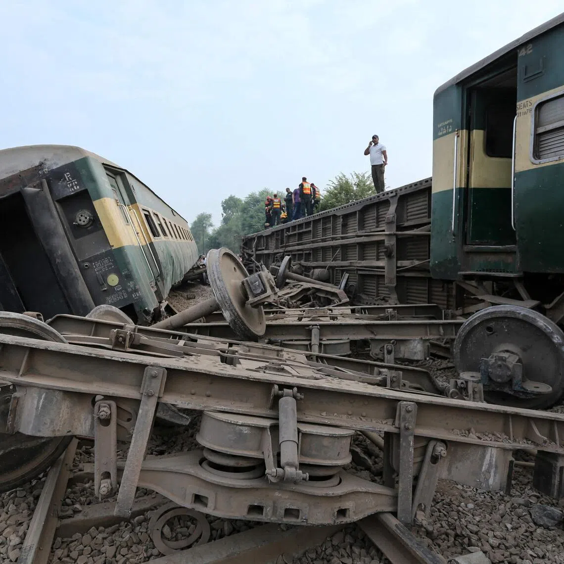 Rescue workers searching for victims following the derailment of the passenger train on the outskirts of Multan in Pakistan on Oct 13.