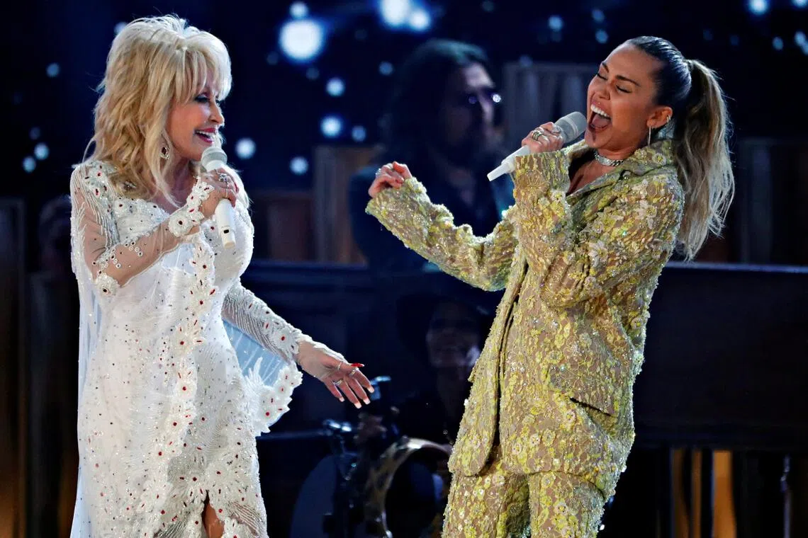 A 2019 photo shows US country music icon Dolly Parton and goddaughter Miley Cyrus performing onstage at the Grammy awards.