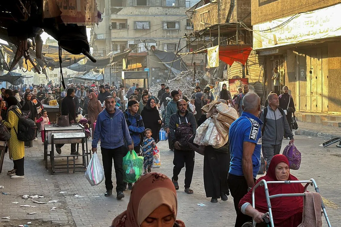 Displaced Palestinians ordered by the Israeli military to evacuate their neighborhoods make their way as they flee amid an Israeli military operation, in Beit Lahiya in the northern Gaza Strip October 22, 2024. REUTERS/Stringer