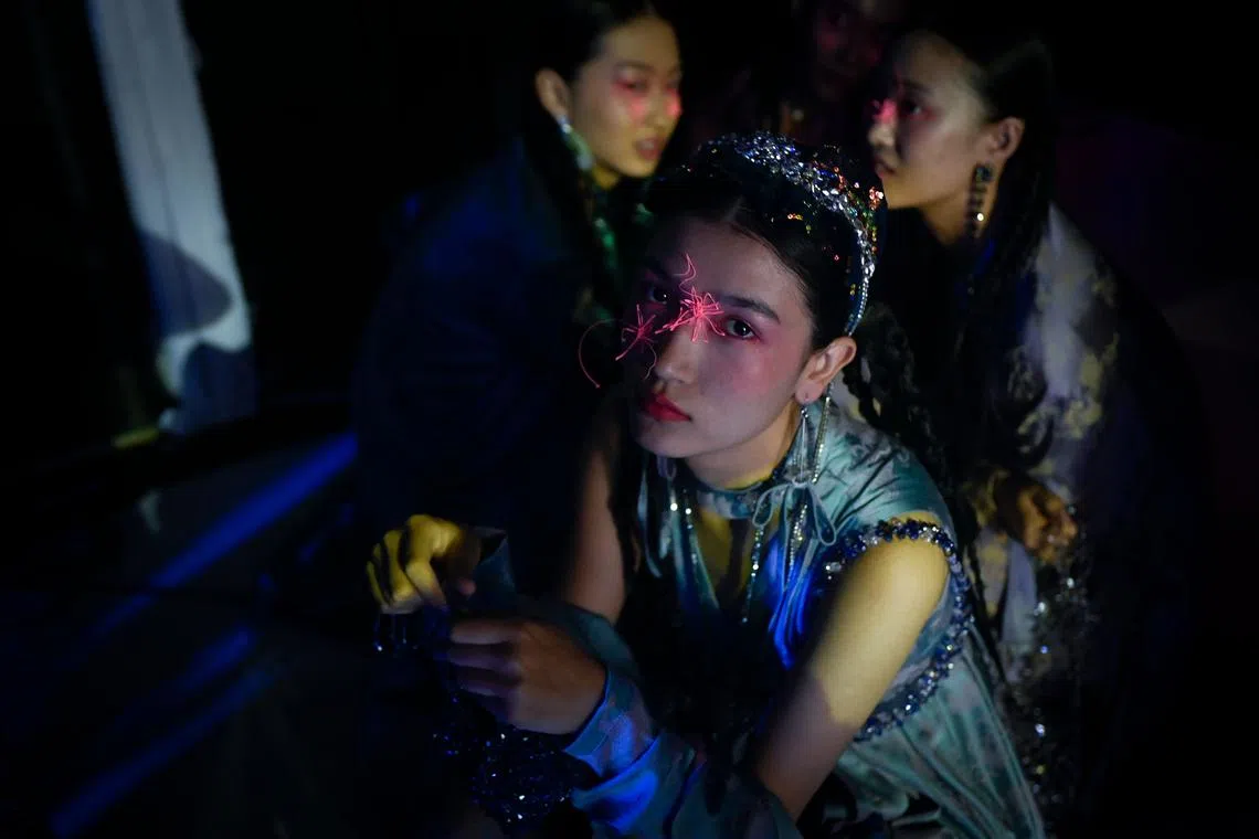 A model waiting backstage before displaying a creation from Moe Ho by He Mengmeng on Sept 8.