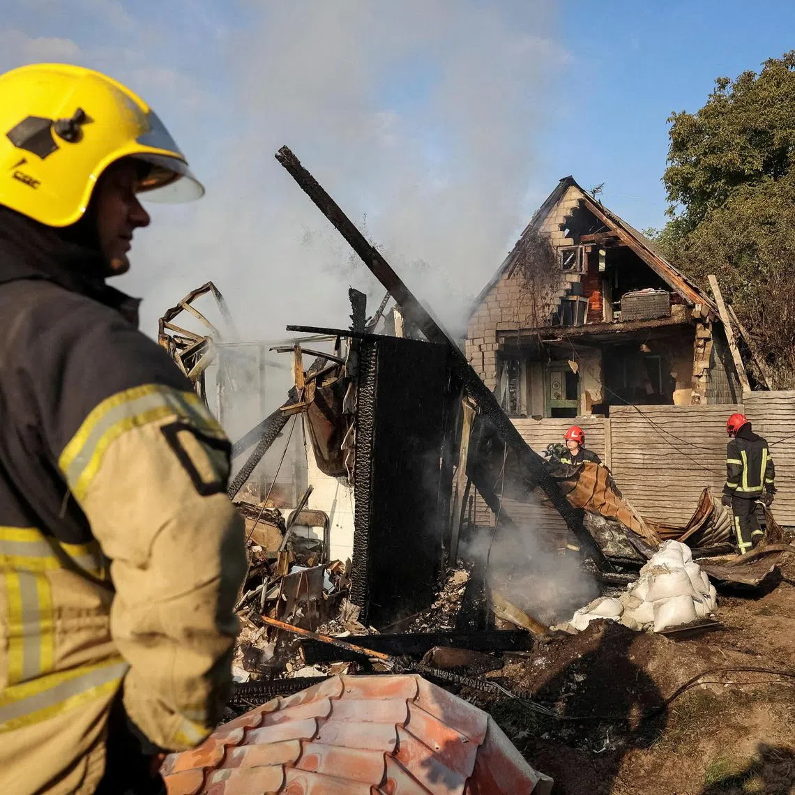 Firefighters working at the site of a Russian missile strike in a village on the outskirts of Lviv, Ukraine, on Aug 21.