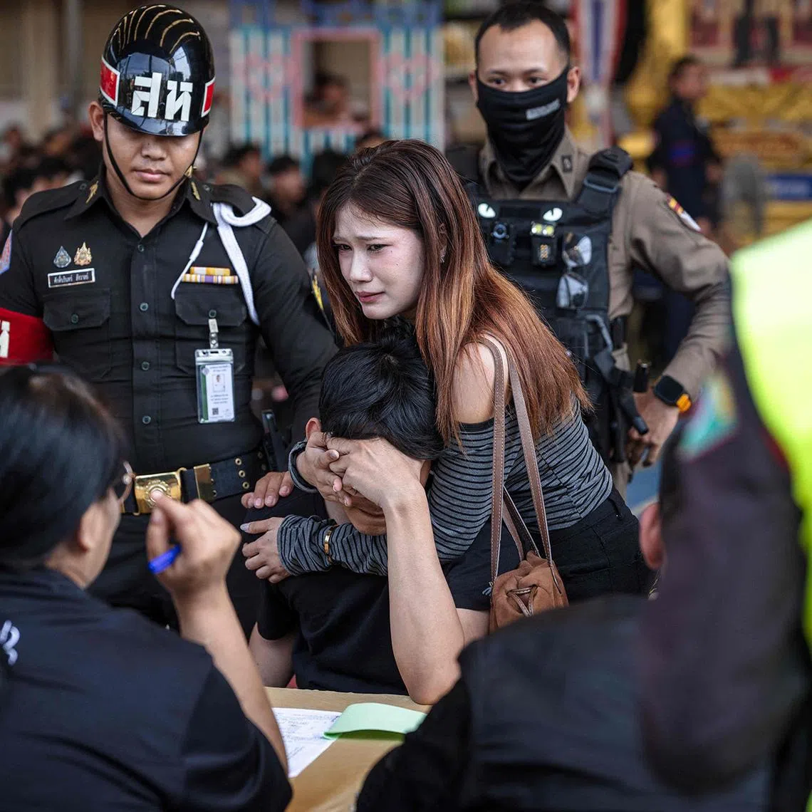 TOPSHOT - A man reacts after picking a red ballot, meaning mandatory enlistment, during the Thai military conscription drawing at Watmatchantikaram School in Bangkok on April 7, 2026. (Photo by chanakarn LAOSARAKHAM / AFP)