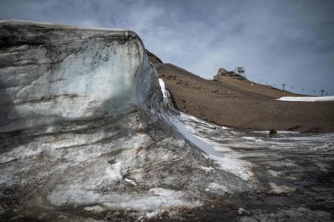 (FILES) In this file photo taken on September 13, 2022 A picture taken on September 13, 2022 at the Glacier 3000 resort above Les Diablerets shows a pile of snow from the last winter season covered with blanket to prevent it from melting next to the Tsanfleuron pass free of the ice that covered it for at least 2,000 years.



the Tsanfleuron pass free of the ice that covered it for at least 2,000 years next to - The year 2023 looks bad again for the Swiss glaciers, the snow cover being about 30% lower than the average of the last 10 years, told AFP the scientist in charge of their monitoring. (Photo by Fabrice COFFRINI / AFP)