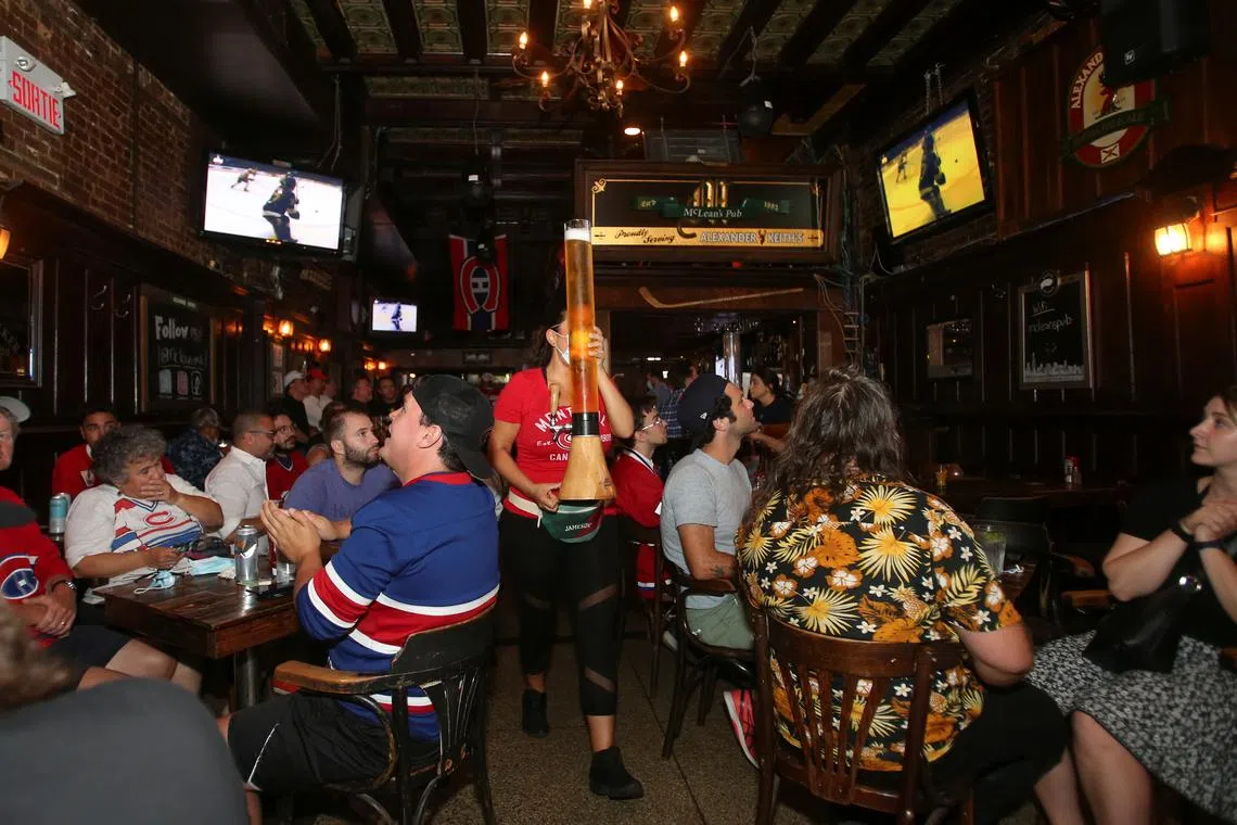 Montreal Canadiens hockey fans gather to watch the second away game of the Stanley Cup Finals, against Tampa Bay Lightning, at Macleans Pub in Montreal, Quebec, Canada June 30, 2021. REUTERS/Christinne Muschi/File Photo
