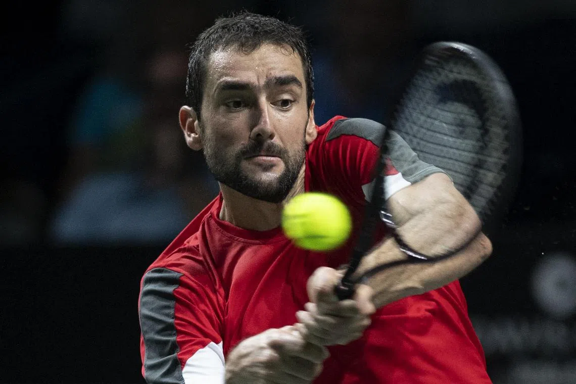 Croatia’s Marin Cilic returns the ball to Australia’s Alex de Minaur during the men's single semi-final tennis match between Australia and Croatia of the Davis Cup tennis tournament at the Martin Carpena sportshall, in Malaga on November 25, 2022. (Photo by JORGE GUERRERO / AFP)