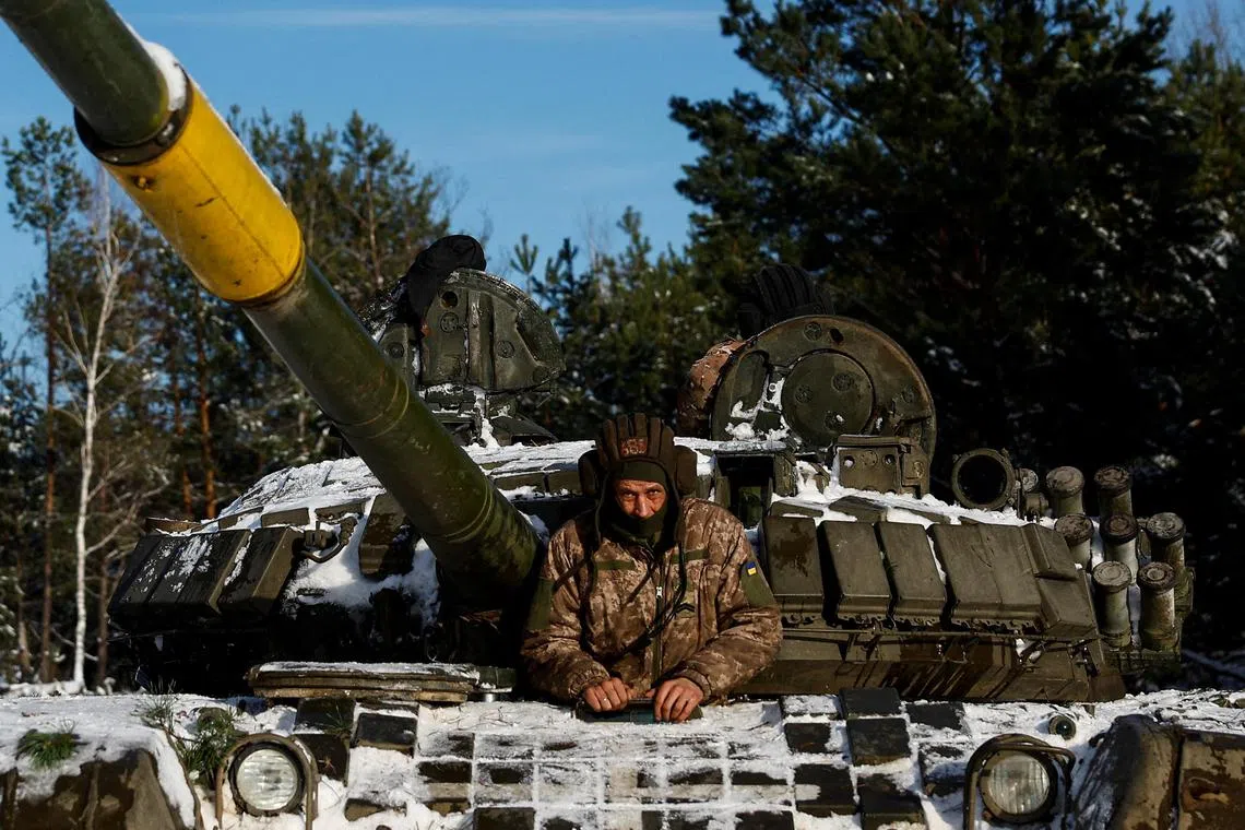 A Ukrainian serviceman sits in a tank during anti-sabotage drills in Ukraine's Chernihiv region.