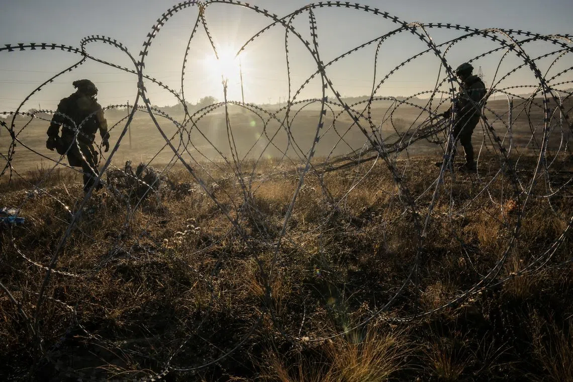 FILE PHOTO: Sappers of the 24th mechanized brigade named after King Danylo install non-explosive obstacles along the front line, amid Russia's attack on Ukraine, in the outskirts of the town of Chasiv Yar in Donetsk region, Ukraine October 30, 2024. Oleg Petrasiuk/Press Service of the 24th King Danylo Separate Mechanized Brigade of the Ukrainian Armed Forces/Handout via REUTERS/File Photo