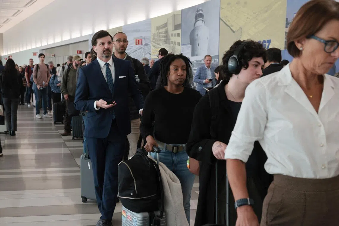 People wait in long security lines at LaGuardia Airport on March 25, 2026 as hundreds of TSA agents have quit or are working without pay during a partial government shutdown. 