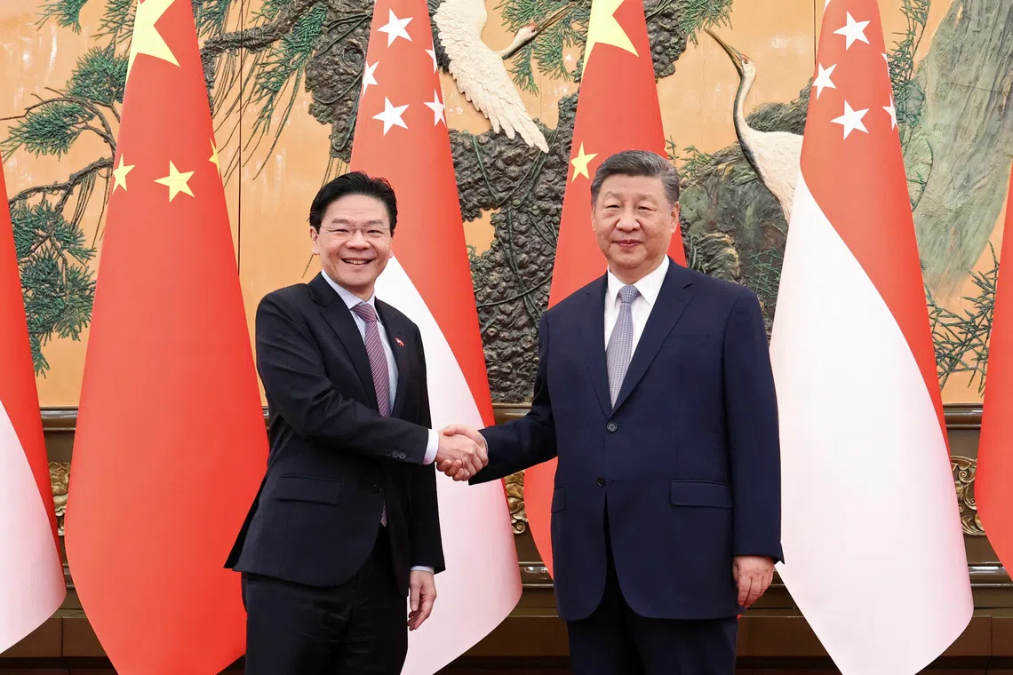 Chinese President Xi Jinping and Singapore Prime Minister Lawrence Wong shake hands at the Great Hall of the People in Beijing, China on June 24.