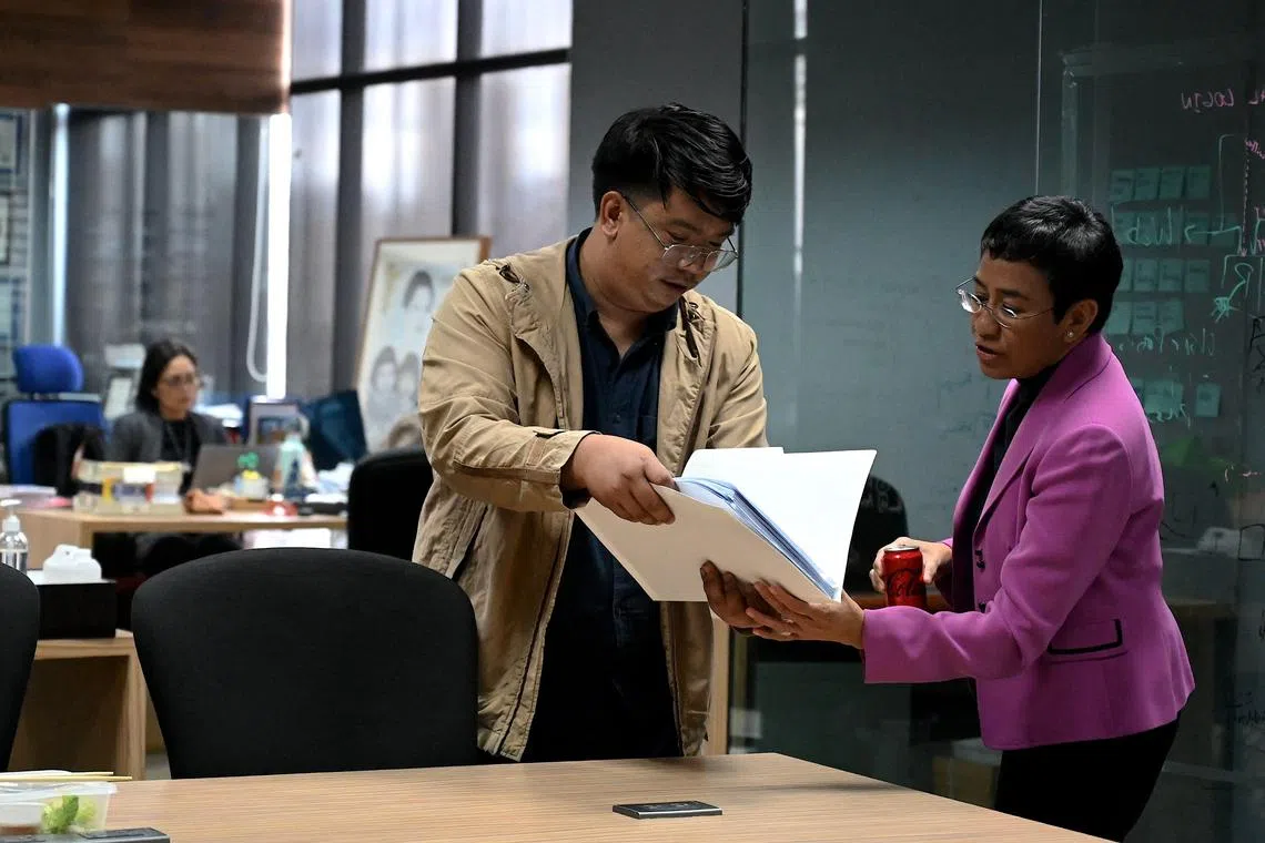 Nobel Laureate Maria Ressa talks to a reporter at the Rappler office in Pasig, Metro Manila on January 18, 2023. - Ressa and her online news outfit Rappler were on January 18, acquitted of all four charges of tax cases filed against her, an appelate tax court said. (Photo by JAM STA ROSA / AFP)