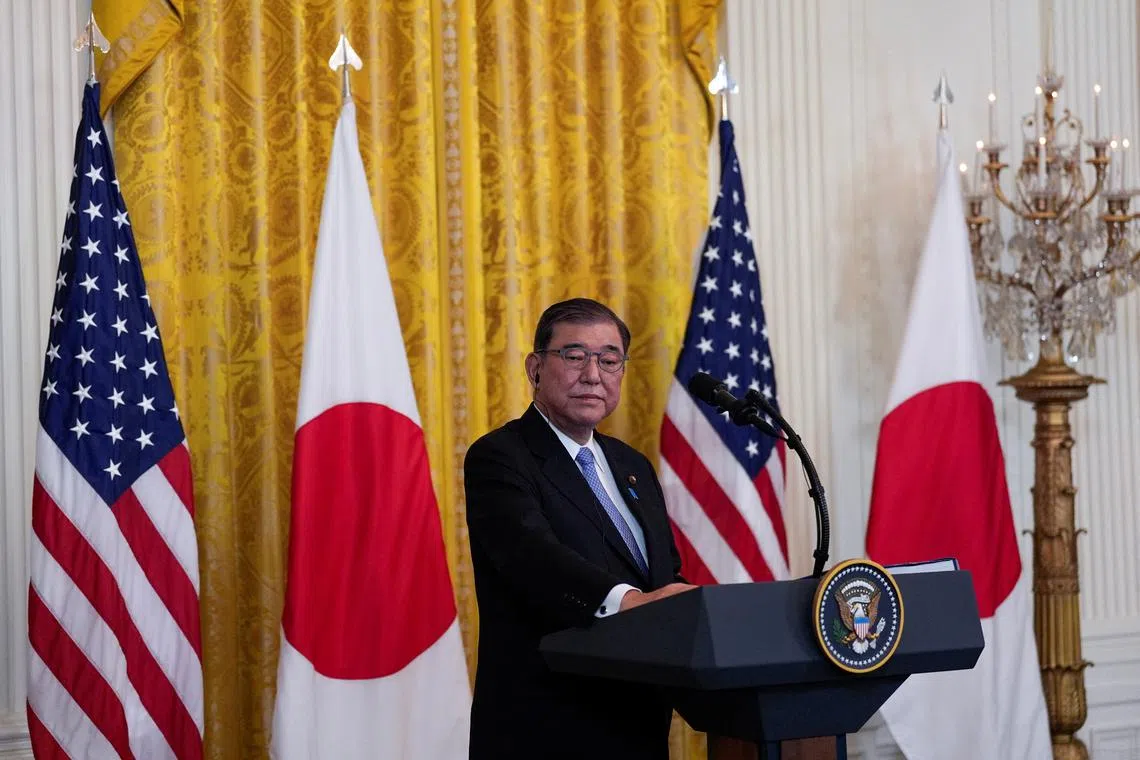 FILE PHOTO: Japanese Prime Minister Shigeru Ishiba attends a joint press conference with U.S. President Donald Trump in the East Room at the White House in Washington, U.S., February 7, 2025. REUTERS/Kent Nishimura/File Photo