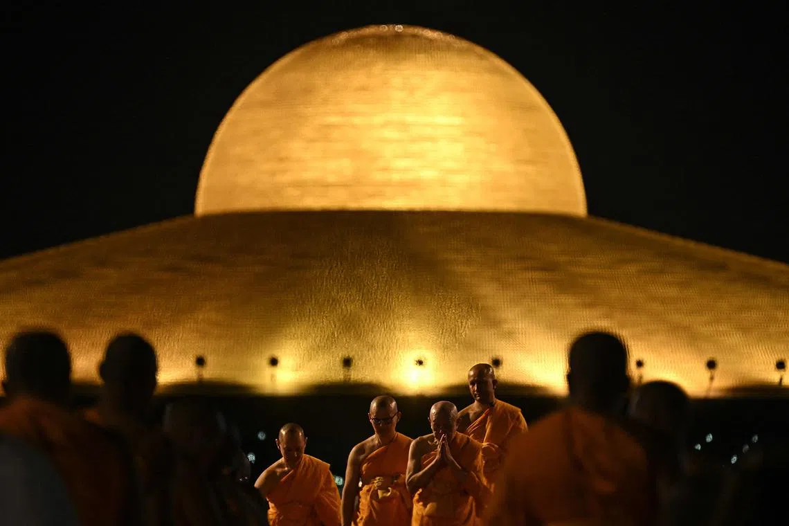 Buddhist monks attending Vesak Day celebrations at Wat Dhammakaya Buddhist temple in Pathum Thani province, north of Bangkok, on May 11, 2025. 