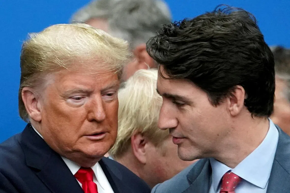 FILE PHOTO: U.S. President Donald Trump talks with Canada's Prime Minister Justin Trudeau during a North Atlantic Treaty Organization Plenary Session at the NATO summit in Watford, Britain, December 4, 2019. REUTERS/Kevin Lamarque/File Photo