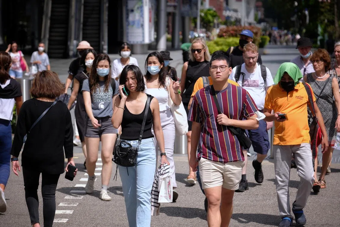 People with masks on and off at Somerset, Orchard Road on March 29, 2022, the first day of relaxation of Covid-19 rules.