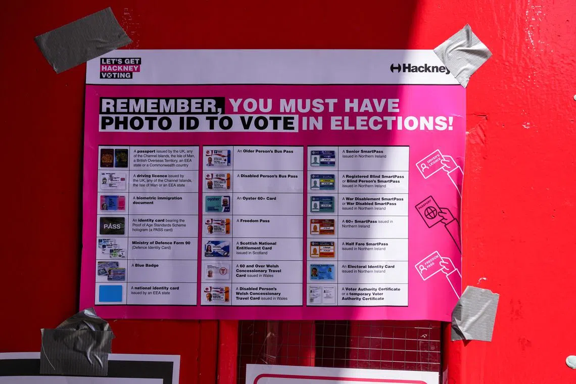 FILE PHOTO: A voter ID information sign is displayed at a polling station during the general election in London, Britain July 4, 2024. REUTERS/Maja Smiejkowska/File Photo