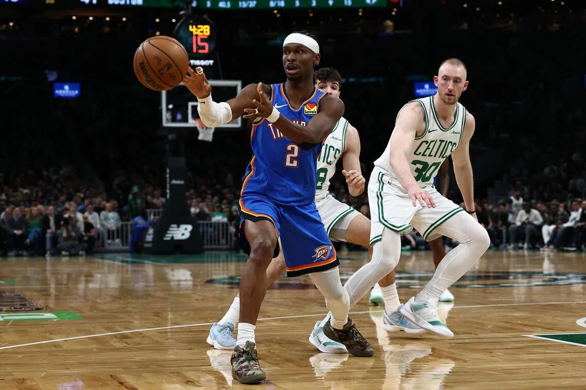 Oklahoma City Thunder guard Shai Gilgeous-Alexander passes out of traffic during the second quarter against the Boston Celtics at TD Garden.