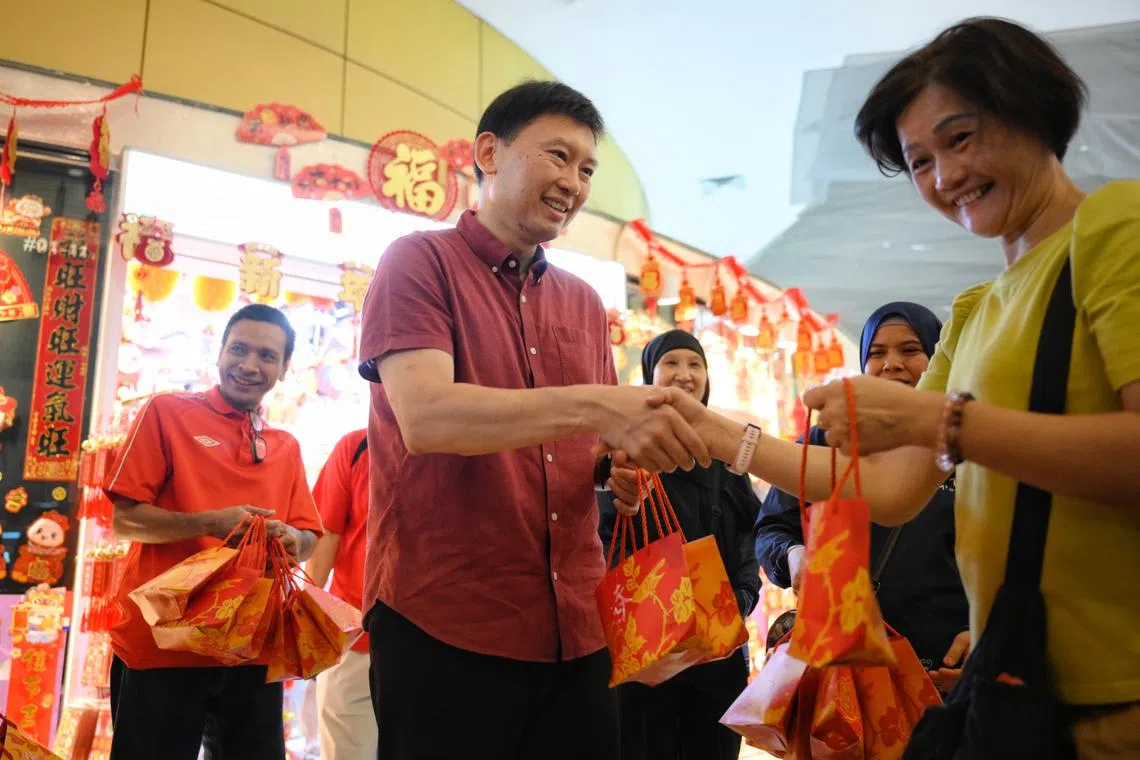 Transport Minister Chee Hong Tat giving out mandarin oranges at a community event on Jan 26.
