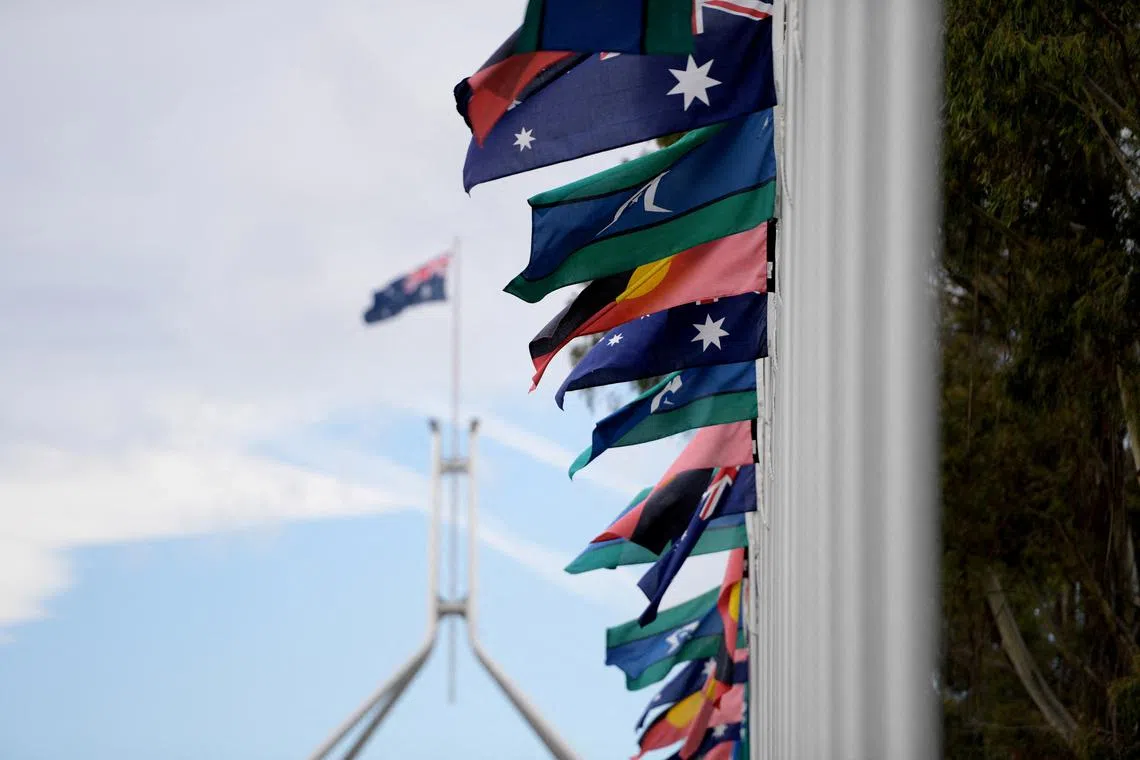 FILE PHOTO: Australian Aboriginal and Torres Strait Islander flags are pictured in front of Parliament House during The Voice referendum in Canberra, Australia, Oct. 14, 2023. REUTERS/Tracey Nearmy/File Photo