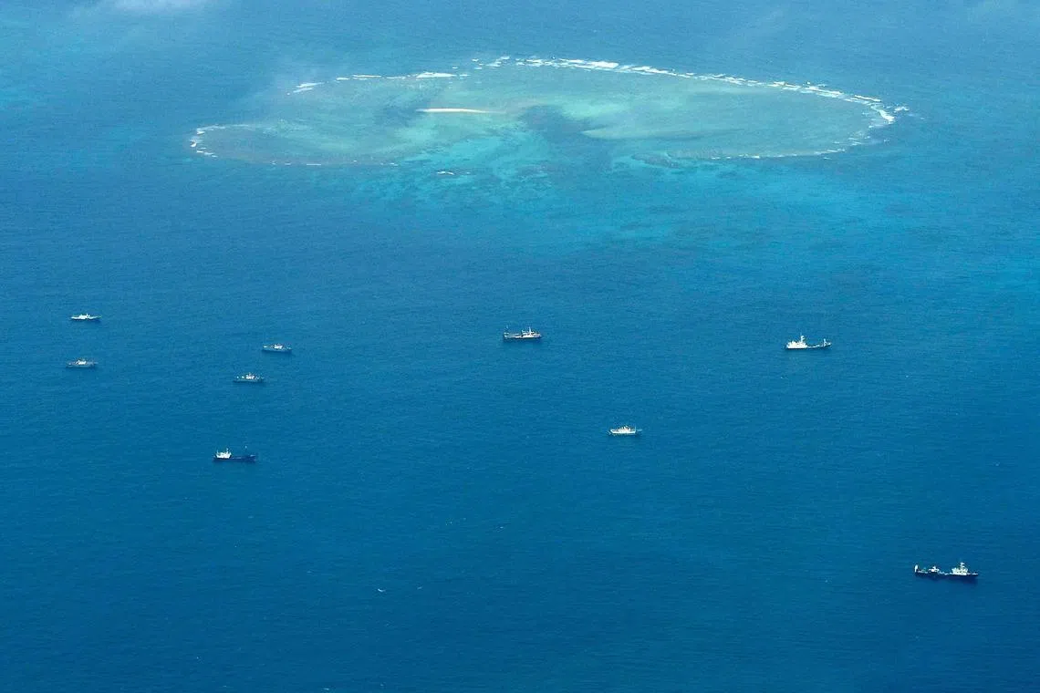 An aerial view shows vessels identified by the Philippine Coast Guard as Chinese maritime militia vessels near Thitu Island in the South China Sea. 