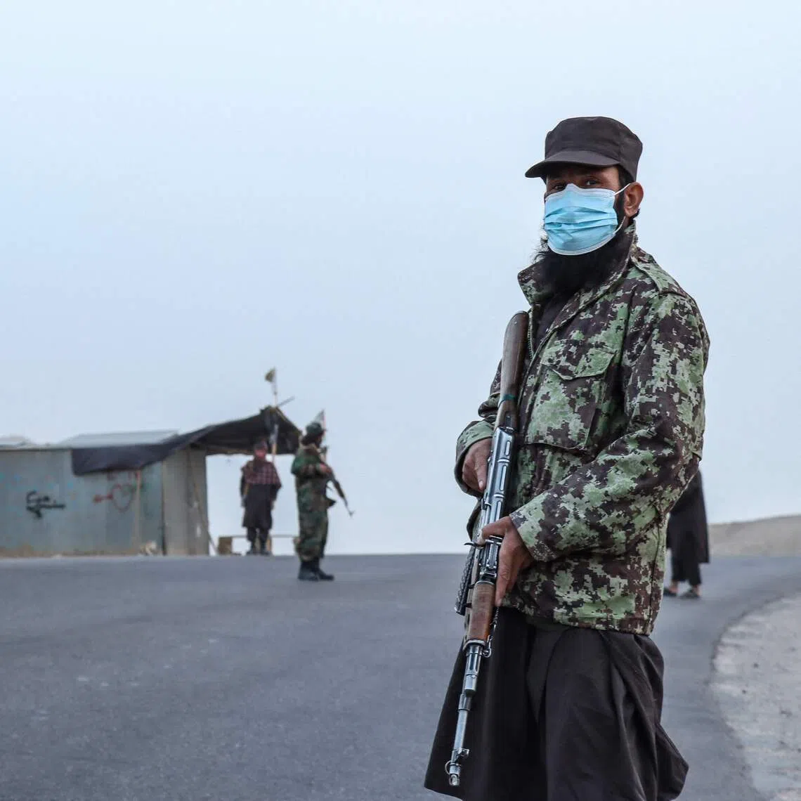 A Taliban security personnel stands guard at a checkpoint on the outskirts of Qala-i-Naw in the Badghis province in October.  A man convicted of murder was publicly executed on Dec 2 in eastern Afghanistan.