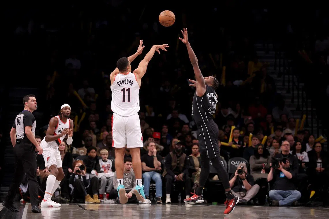 Portland Trail Blazers guard Malcolm Brogdon (No. 11) taking a three-point shot against Brooklyn Nets during overtime at Barclays Centre.