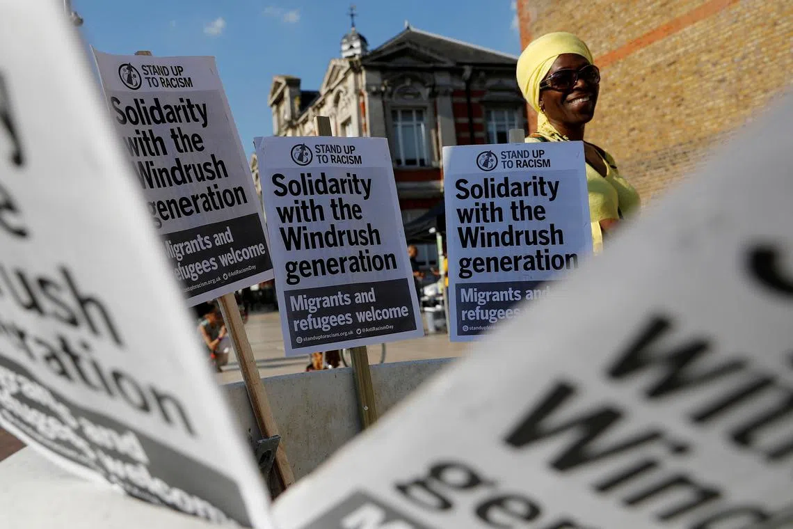 FILE PHOTO: A woman attends an event in Windrush Square to show solidarity with the Windrush generation in the Brixton district of London, Britain April 20, 2018.  REUTERS/Darren Staples/File Photo