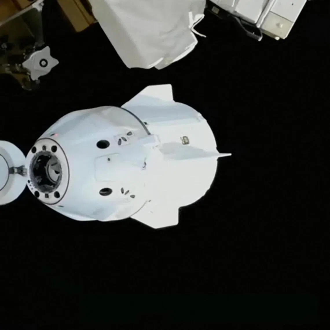 This screengrab shows a SpaceX capsule carrying three astronauts and a cosmonaut undocking from the ISS. 
