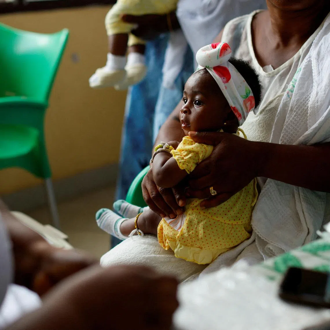 FILE PHOTO: An infant waits to receive a dose of the RTS,S malaria vaccine, also known as Mosquirix, at the Mother and Child Hospital in Kasoa, Ghana, November 19, 2025. REUTERS/Francis Kokoroko/File Photo