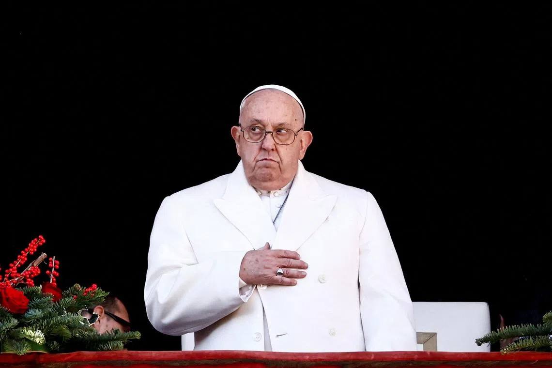 FILE PHOTO: Pope Francis reacts, on the day he delivers his traditional Christmas Day Urbi et Orbi speech to the city and the world from the main balcony of St. Peter's Basilica at the Vatican, December 25, 2024. REUTERS/Yara Nardi/File Photo