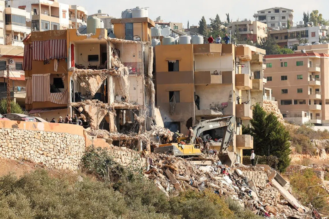 Civil defense members work at a site damaged in the aftermath of an Israeli strike, amid the ongoing hostilities between Hezbollah and Israeli forces, in Barja, Lebanon November 6, 2024. REUTERS/Aziz Taher