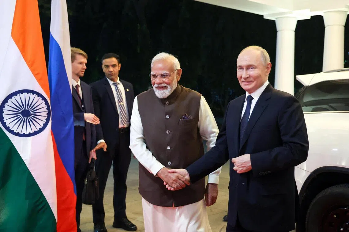 Indian Prime Minister Narendra Modi (left) and Russian President Vladimir Putin arriving for an informal dinner at the Prime Minister's Residence in New Delhi, on Dec 4.
