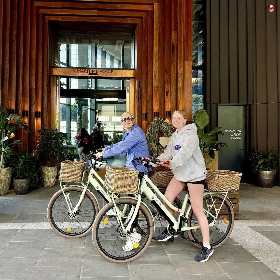 The writer and her daughter on e-bikes at 1 Hotel Melbourne.