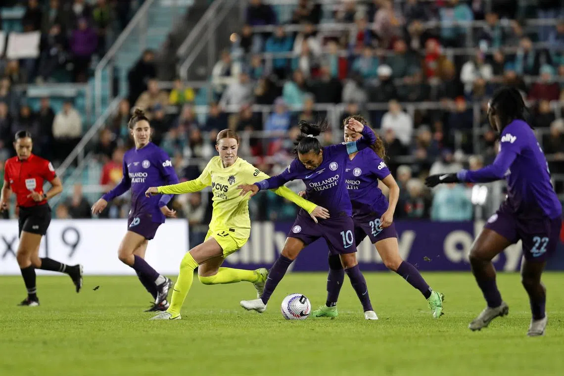 Nov 23, 2024; Kansas City, Missouri, USA; Washington Spirit midfielder Hal Hershfelt (17) battles for the ball against Orlando Pride forward Marta (10) during the second half in the 2024 NWSL Championship match at CPKC Stadium. Mandatory Credit: Kylie Graham-Imagn Images
