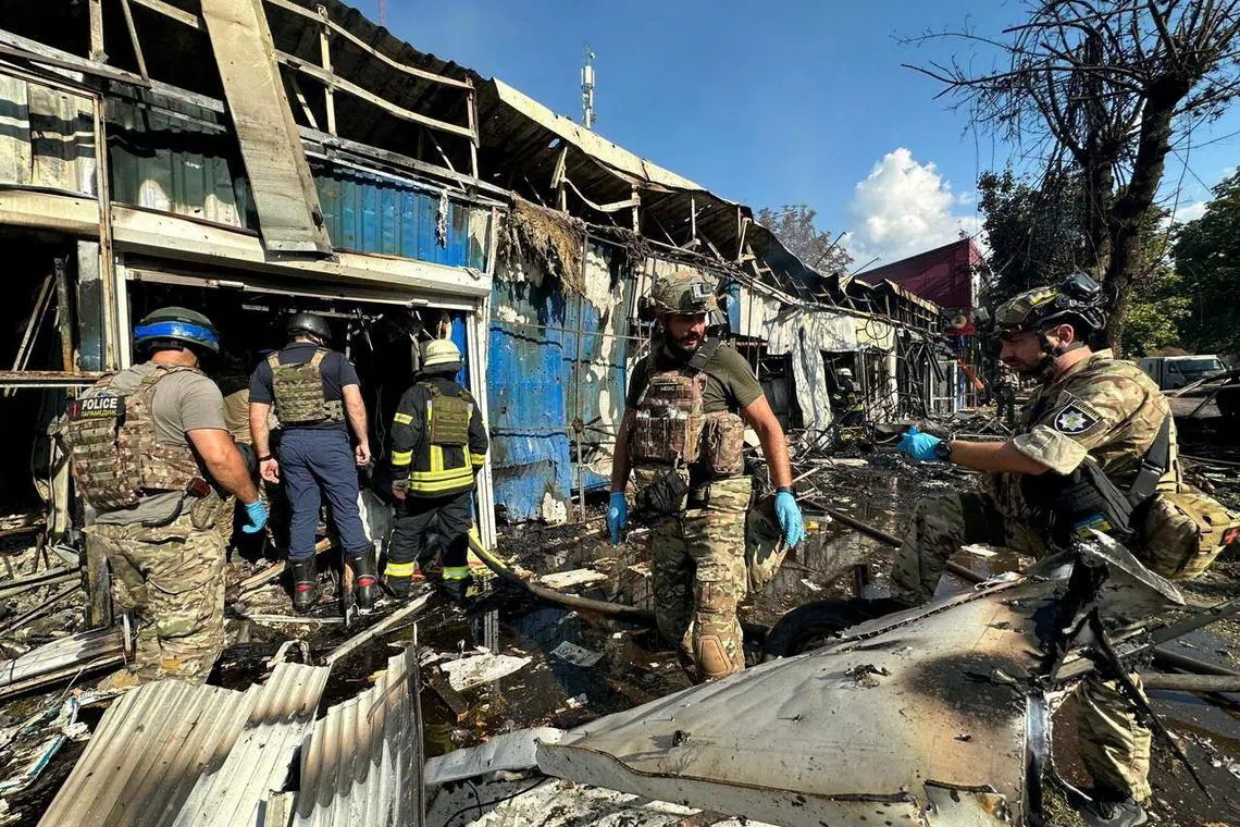 Police officers and rescuers inspect the site of a Russian military strike in Kostiantynivka, in Ukraine's Donetsk region, in which at least 17 people were killed.