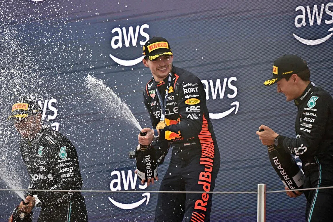 Red Bull driver Max Verstappen celebrate on the podium following his win at the Spanish Grand Prix. 