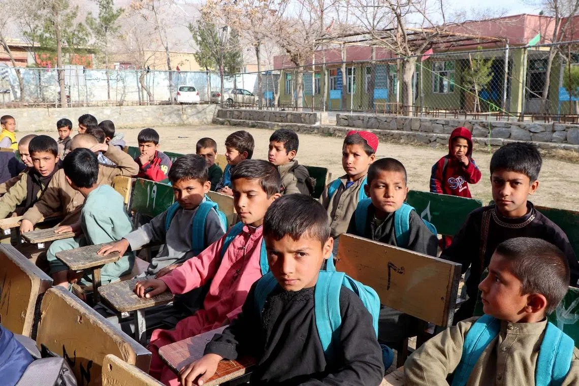 Afghan school boys attend their first class following the start of the new academic year, at a school in Charikar city of Parwan province on March 20, 2024. Schools in Afghanistan opened for the new academic year on March 20, the education ministry said, with girls banned from joining secondary-level classes for the third year in a row. (Photo by Abdul SHAHMIM TANHA / AFP)
