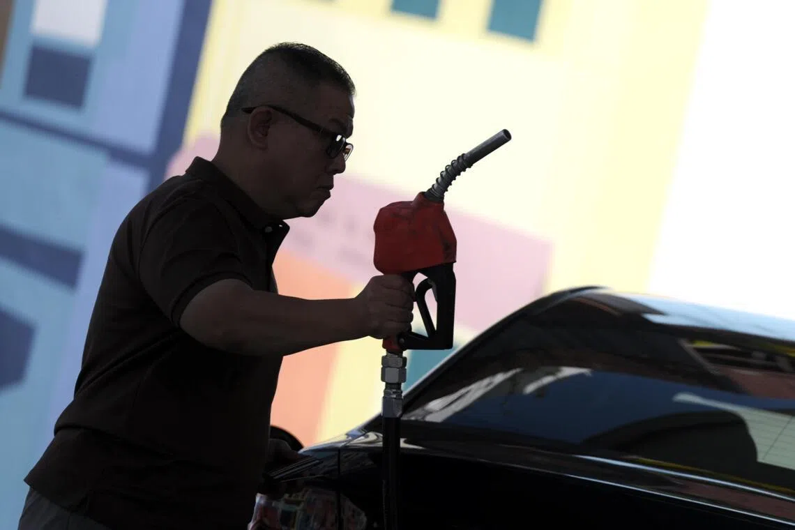 A man pumps his car with petrol at Cnergy petrol station along Dunman Road on March 17, 2026.