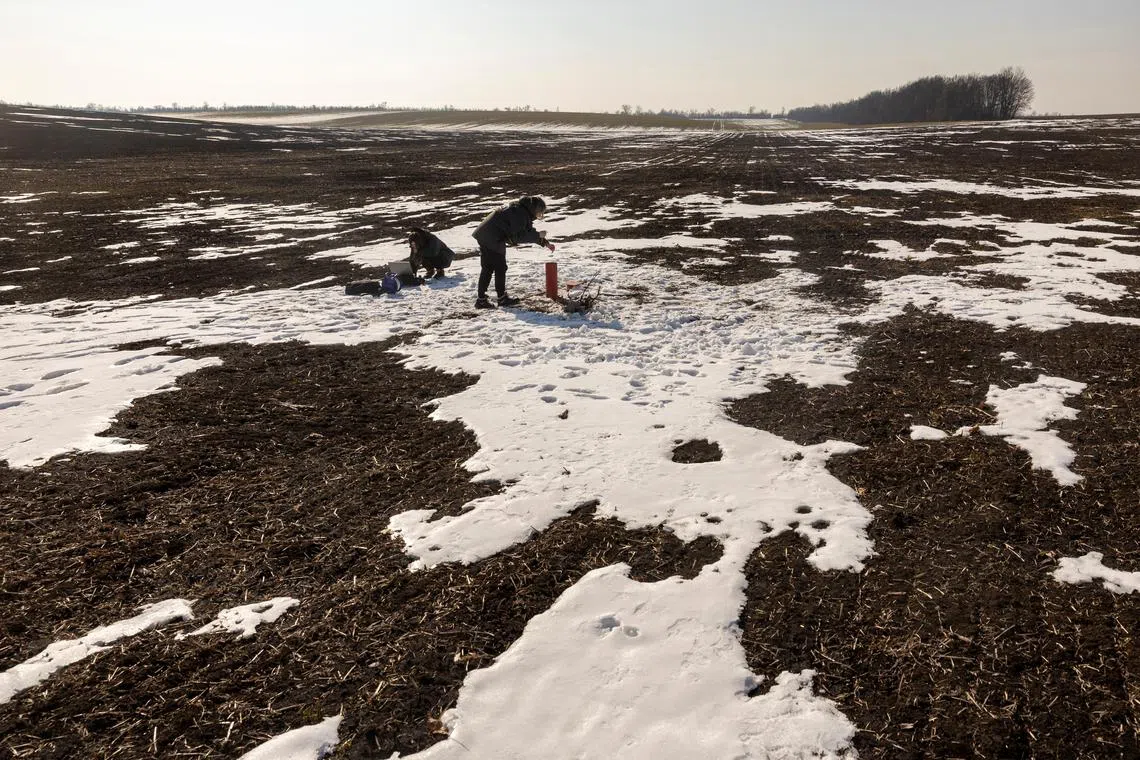 FILE PHOTO: Environmental experts of CDM Engineering Ukraine,Yuliia Zazerina and Alina Tatarchuk, test the groundwater level at the Polokhivske lithium deposit that will be developed by Ukrlithium Mining in the Malovyskivsky district of Ukraine’s Kirovograd region, amid Russia's attack on Ukraine, February 27, 2025.  REUTERS/Thomas Peter/File Photo