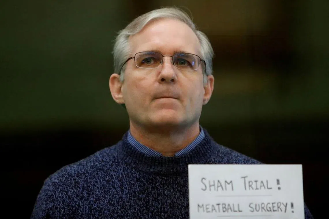 FILE PHOTO: Former U.S. Marine Paul Whelan, who was detained and accused of espionage, stands inside a defendants' cage during his verdict hearing in Moscow, Russia June 15, 2020. REUTERS/Maxim Shemetov/File Photo