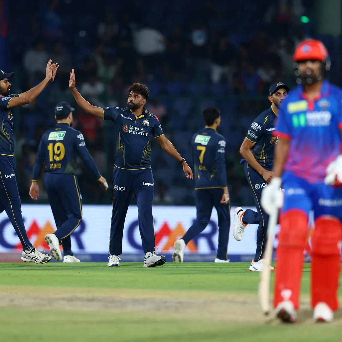 Cricket - Indian Premier League - IPL - Delhi Capitals v Gujarat Titans - Arun Jaitley Stadium, New Delhi, India - April 8, 2026 Gujarat Titans' Mohammed Siraj celebrates with teammates after taking the wicket of Delhi Capitals' KL Rahul, caught out by Jos Buttler REUTERS/Anushree Fadnavis