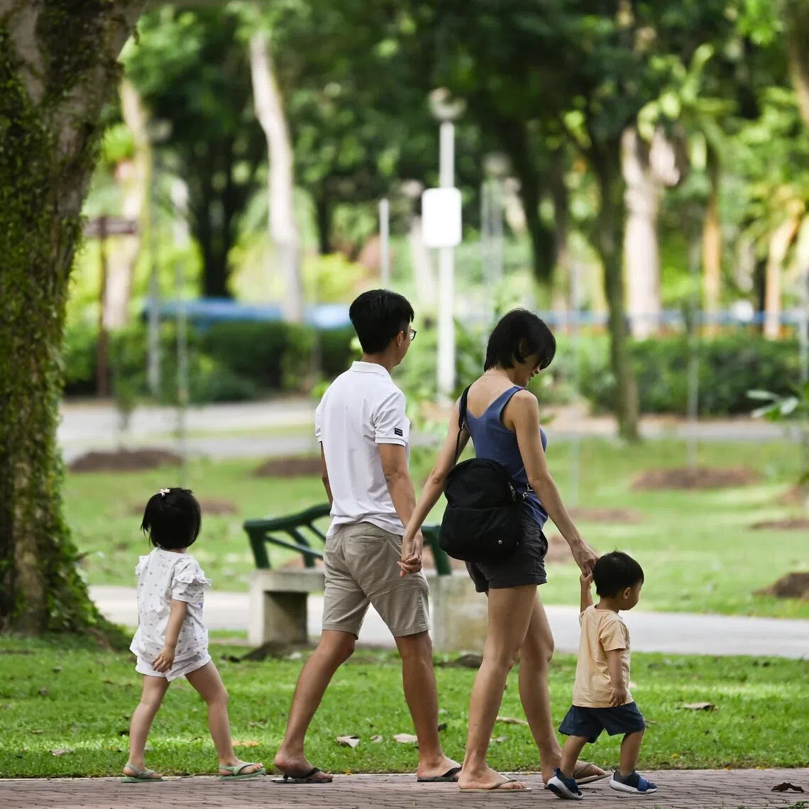 A family with two children walking at Sun Plaza Park on Apr 7, 2023. Can be used for stories on population, budget, love, relationship, family, life, children and marriage. 