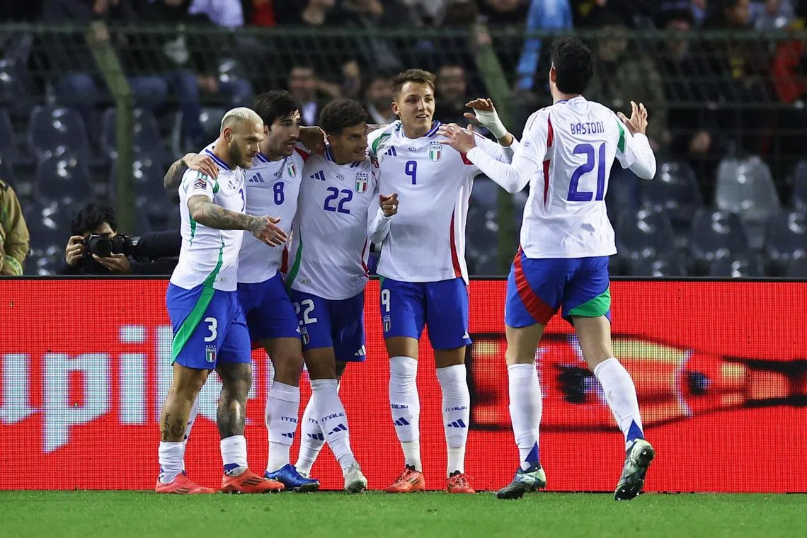 Italy's Sandro Tonali celebrates scoring his winning goal with teammates.