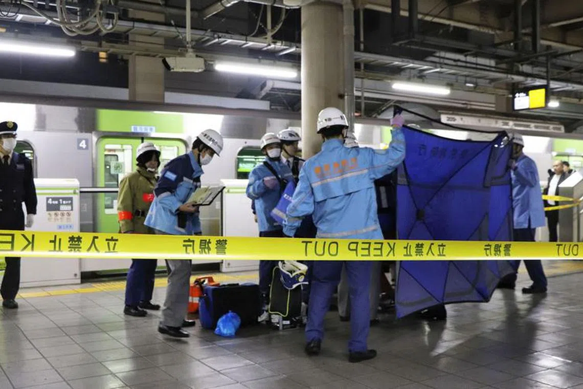 A person who believed to have been stabbed by a knife on the Yamanote loop train line is transported by ambulance members at JR Akihabara Station in Tokyo,  Japan January 3, 2024, in this photo released by Kyodo. Mandatory credit Kyodo via REUTERS